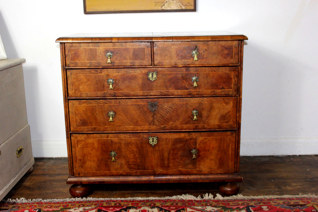 Queen Anne burr walnut chest of drawers circa 1710 with crossbanded top and bun feet