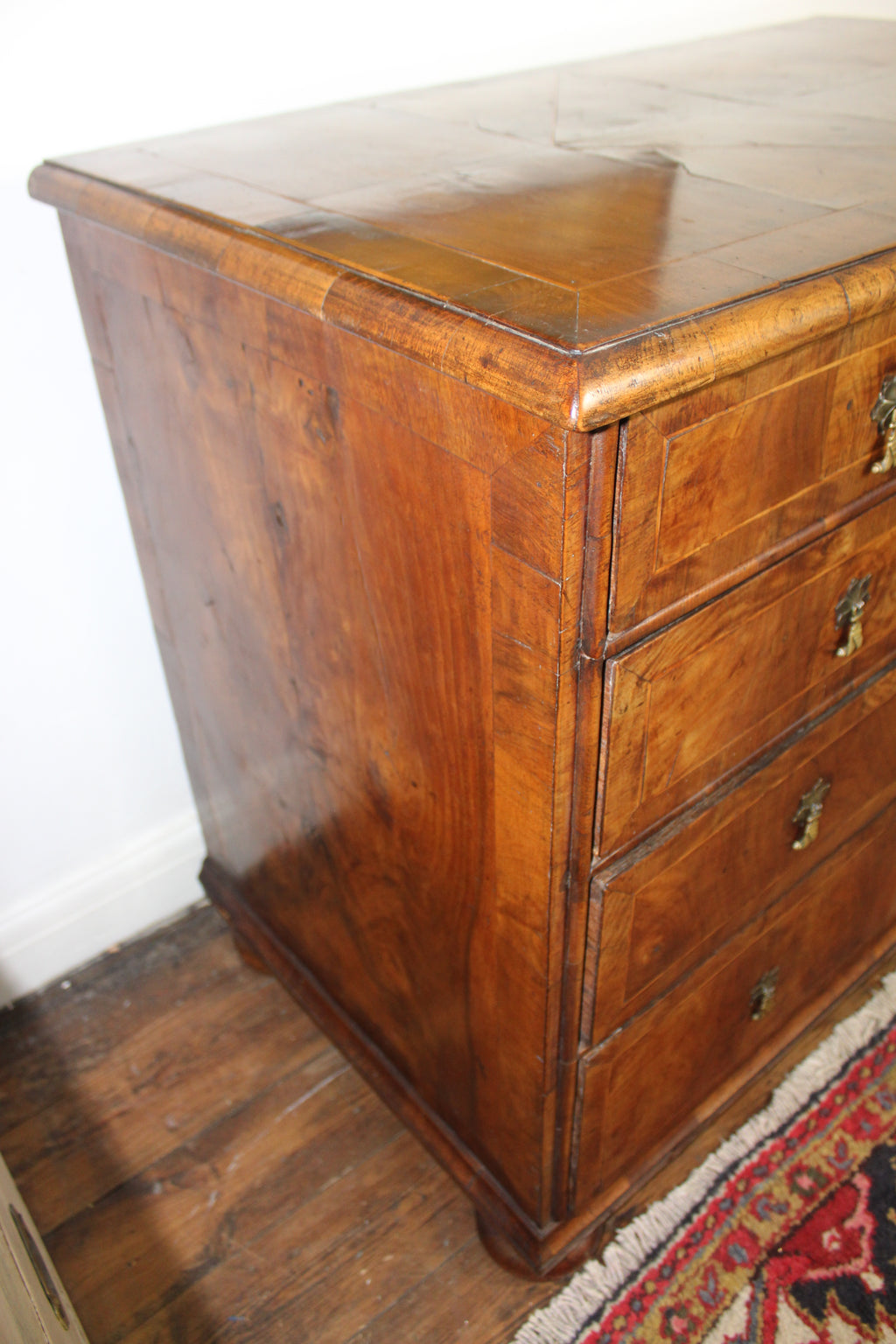 bun feet detail on early 18th century English walnut chest of drawers